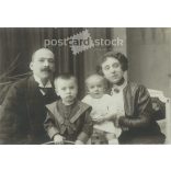 Family photo with children. The people in the photo and the photographer are unknown. Original old photo. Black and white, laminated photo, original paper photo. (2793650)