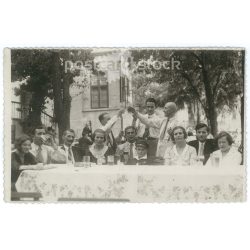   Cheerful company at a family gathering. The people in the picture and the photographer are unknown. Original old photo. Black and white photo sheet, old postcard. (2793651)