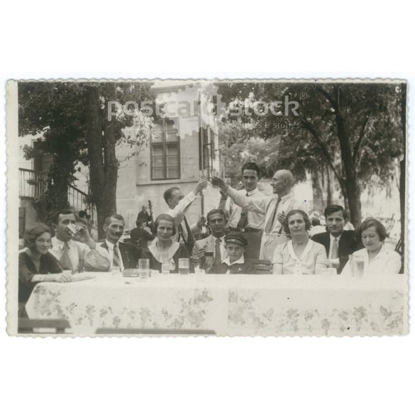 Cheerful company at a family gathering. The people in the picture and the photographer are unknown. Original old photo. Black and white photo album, old postcard. (2793651)