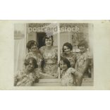 Girls in identical clothes. The people in the picture and the photographer are unknown. Original old photo. Black and white photo sheet, old postcard. (2793670)