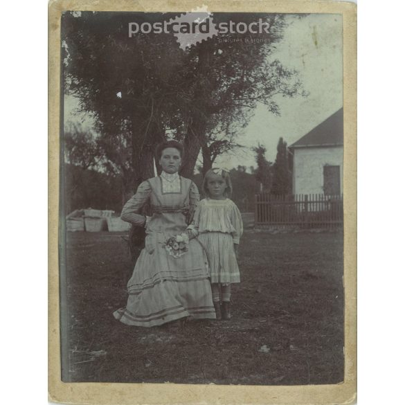 Circa 1910. Mother and daughter. The people in the picture and the photographer are unknown. Original old photo. Black and white, laminated photo, original paper image. (2793752)