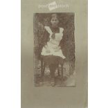Circa 1910 - Full-length photo of a young girl. The person in the photo and the photographer are unknown. Old photo. Black and white photo sheet, original paper image. (2793759)