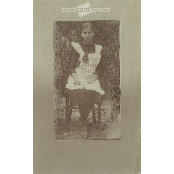 Circa 1910 - Full-length photo of a young girl. The person in the photo and the photographer are unknown. Old photo. Black and white photo sheet, original paper image. (2793759)