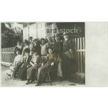 Circa 1915 - Family photo with soldiers. The people in the photo and the photographer are unknown. Old photo. Black and white photo sheet, original paper image. (2793798)