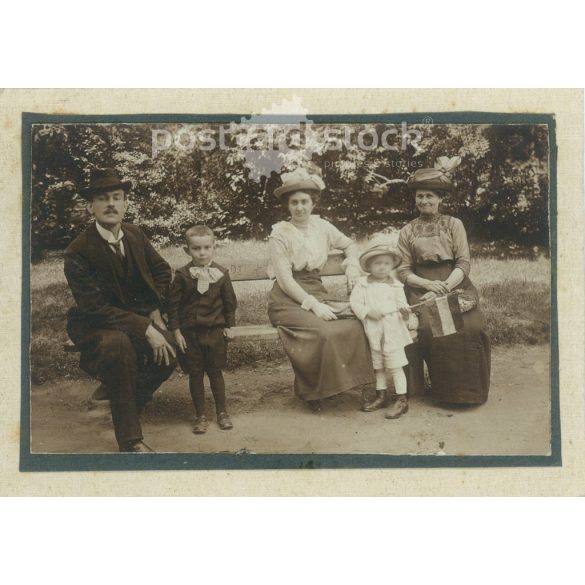 Afternoon in the park. Family photo. The people in the photo and the photographer are unknown. Original old photo. Black and white, laminated photo, original paper photo. (2793850)
