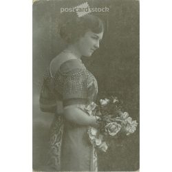   Unknown young lady, in elegant attire. The author of the picture is unknown. Original paper image. Black and white photo, old postcard. (2793859)