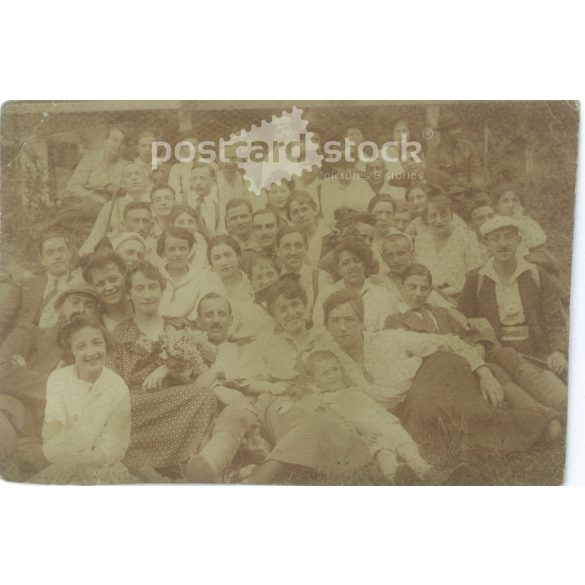 1919 - Group photo outdoors. The photo shows young people on an excursion. The identity of the people in the photo and the photographer are unknown. Original old photo. Black and white photo album, old postcard. (2793886)