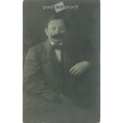   1912 - Studio photo of a middle-aged man. The person in the photo and the photographer are unknown. Original old photo, gelatin silver. Black and white photo plate, old postcard. (2793894)