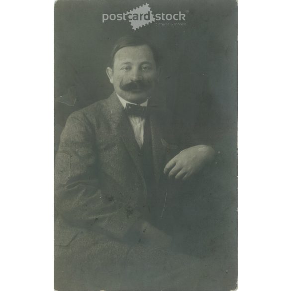 1912 - Studio photo of a middle-aged man. The person in the photo and the photographer are unknown. Original old photo, gelatin silver. Black and white photo plate, old postcard. (2793894)